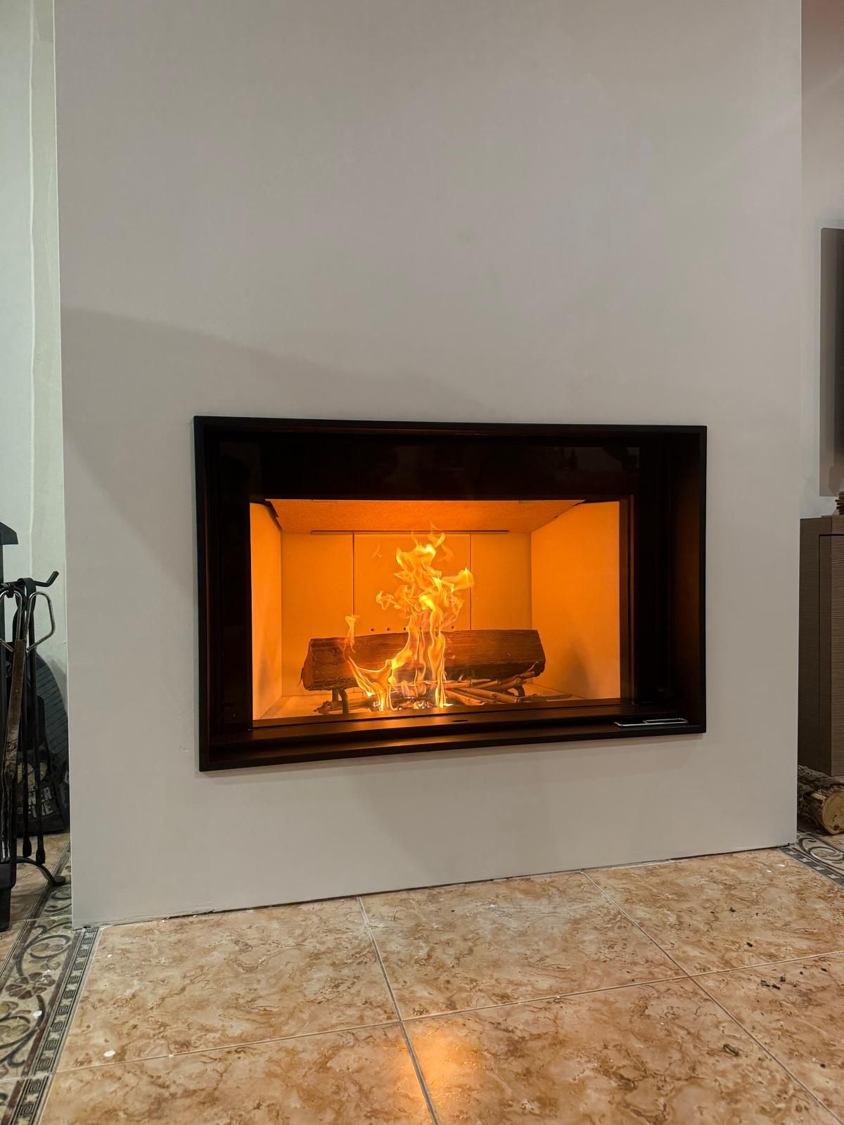Insert encastré dans un habillage blanc, feu allumé